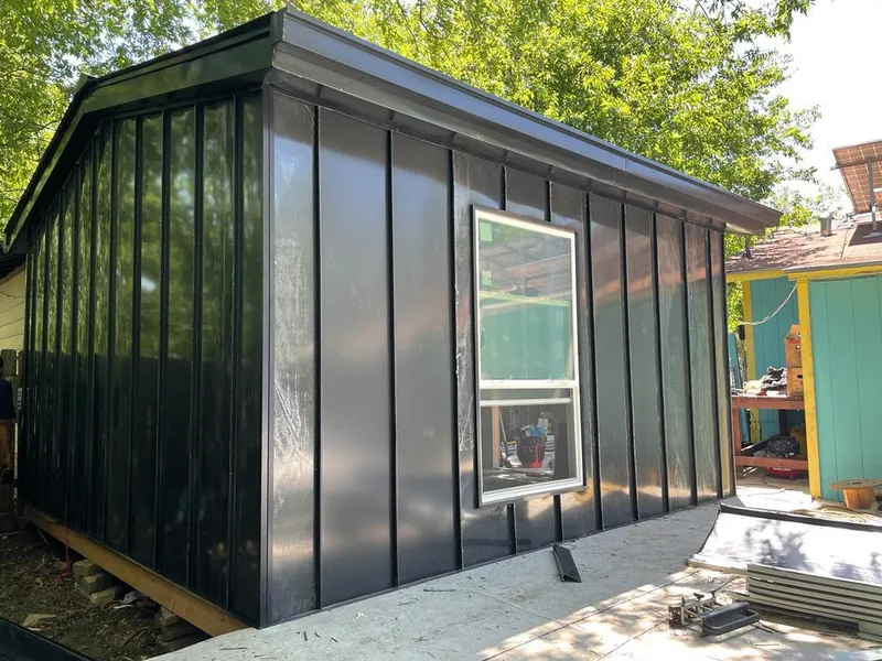 Black standing seam metal wall panels for Roof Inspection in Vancleave