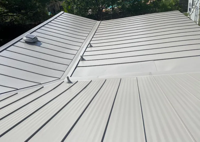Solar attic fan installed on a metal roof for Roof Ventilation in Vancleave